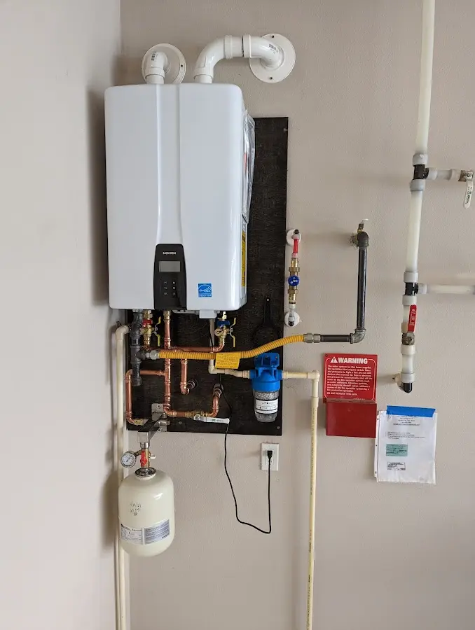 Professional plumber installing copper piping in a Glencoe home